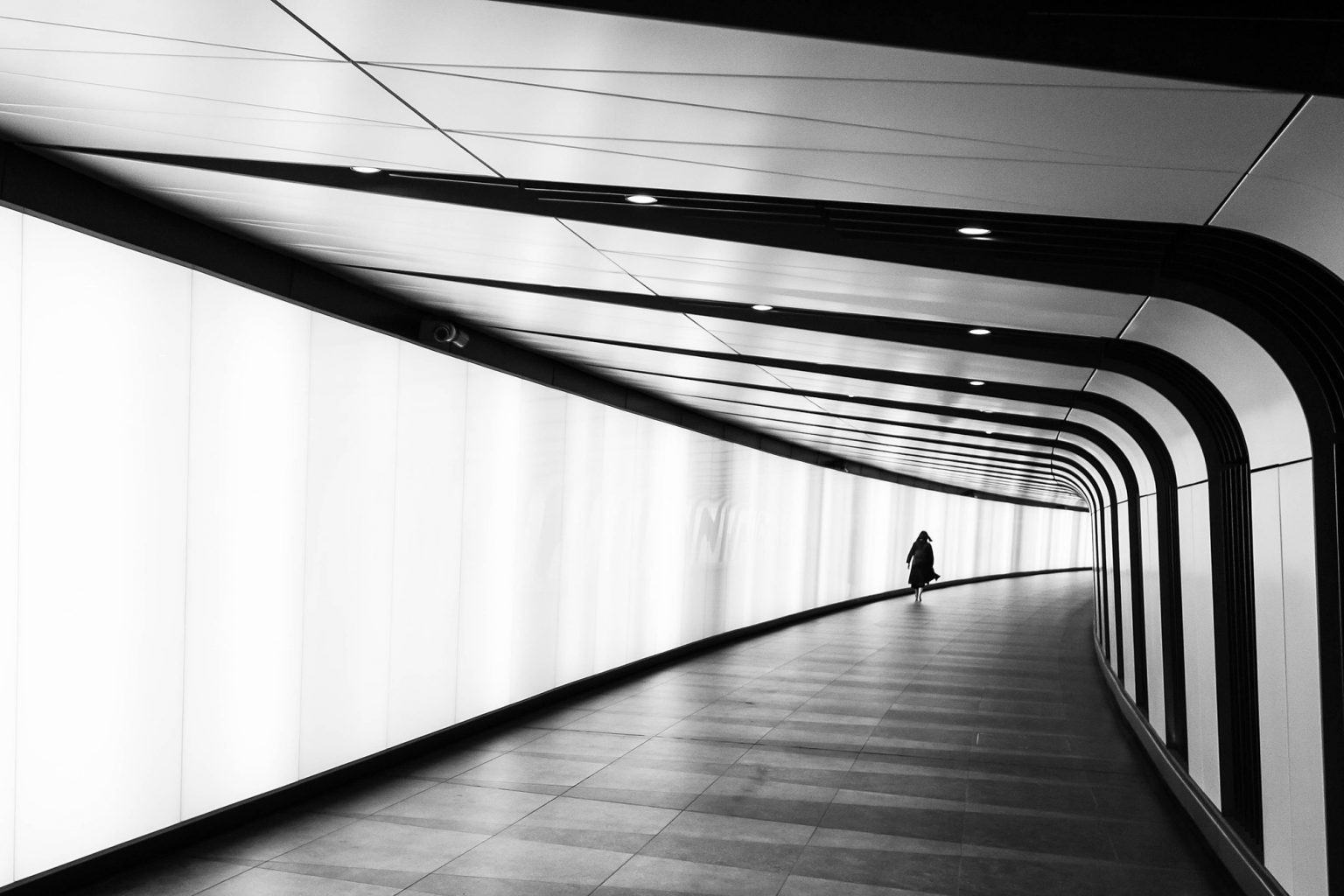A photo of a woman in a tube or rail station